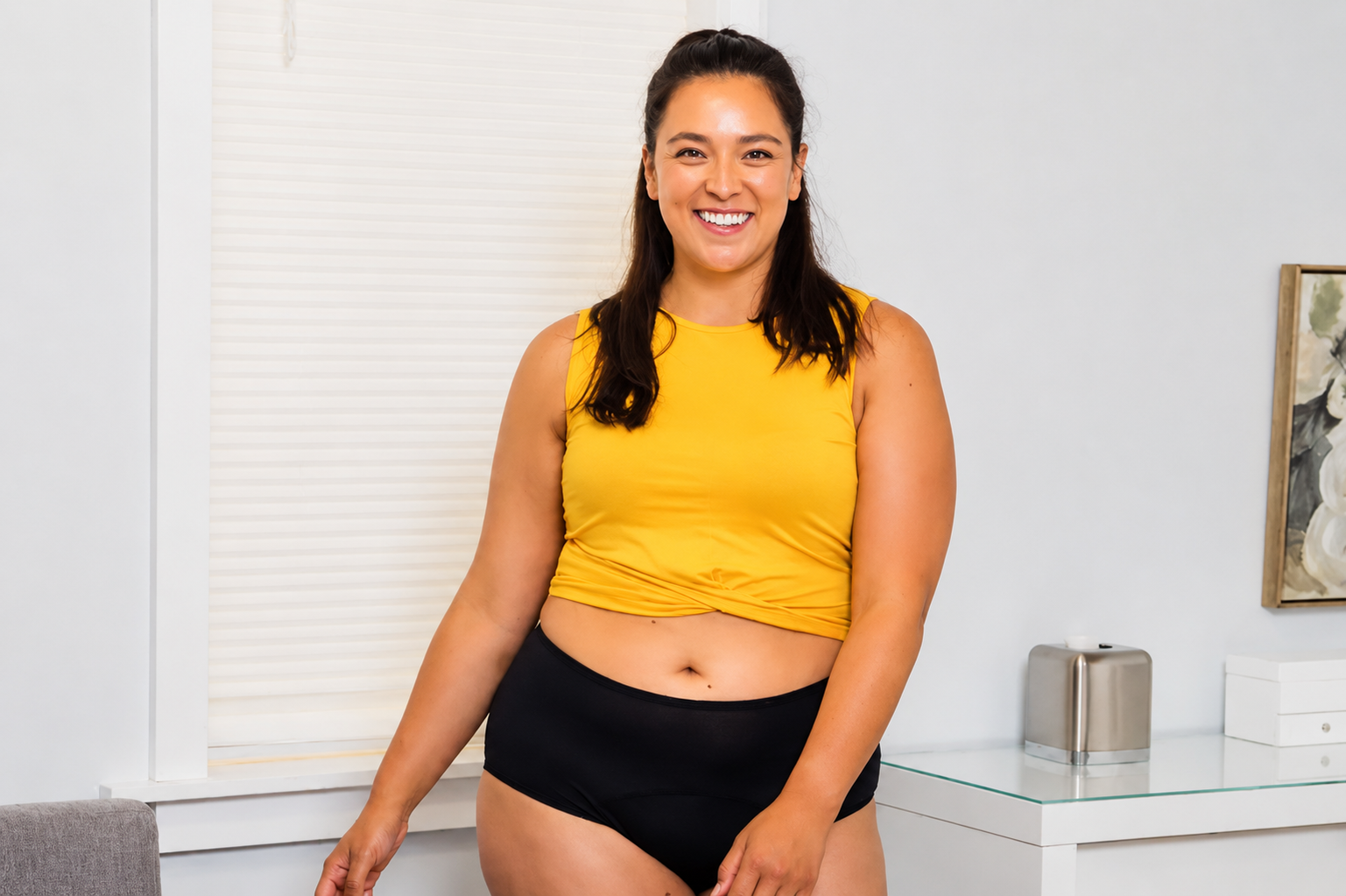 Smiling woman at home wearing black DryGuard leak-proof incontinence underwear